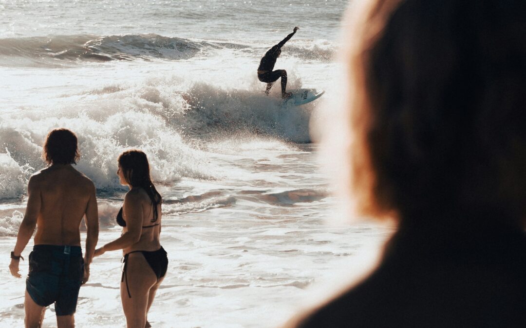 Man surfing while couple looks on